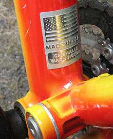 Bottom bracket and suspension linkage of a bright orange Klein Adept Comp