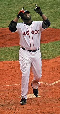 David Ortiz points to the sky as he steps on home plate.