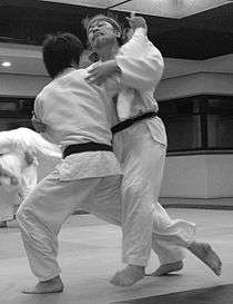 Judoka attempting Ōuchi-gari during randori.