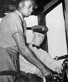 A black PTC employee is receiving instruction as a trolley operator