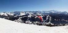 A paraglider lifts off from above Mont Chery, looking out over Les Gets.