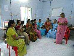 A group of women in India receiving instruction in health education