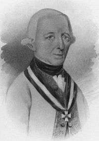 Black and white print of a man with a long nose and a small mouth wearing a powdered wig with the hair curled up at the ears. He wears a while military uniform with a Maria Theresa Cross.
