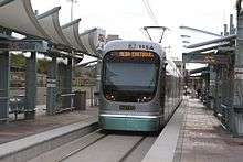 photo of streamlined light rail car pulling into a station