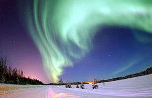 The Aurora Borealis, or Northern Lights, shines above Bear Lake, Eielson Air Force Base, Alaska.