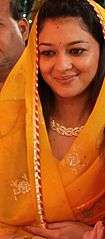 Priyadarshini Raje Scindia wearing a golden-yellow sari.