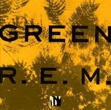 A golden yellow background with dark green impressions of leaves on it and the words "GREEN" and "R.E.M." written on top in black