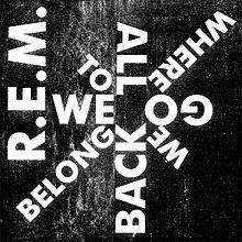 A black background with "R.E.M." written in white along the left side and "WE / TO / ALL / WHERE / GO / WE / BACK / BELONG" written in white in a starburst design, clockwise from left-to-right