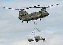 A vehicle being carried underneath a helicopter