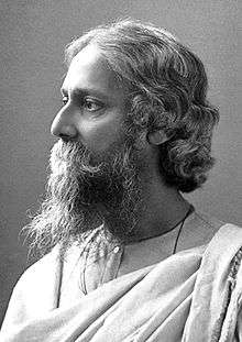 A black and white photograph of an Indian man with a beard, looking left