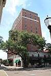 Ground-level view of a 12-story building with a red brick facade.