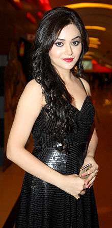 Ragini Nandwani, in a black dress