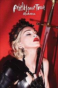 Madonna with her eyes closed in a warrior's dress, holding a sword close to her heart