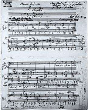 Page of sheet music, the autograph of Reger's Requiem of 1915, with handwritten title and dedication on the lines for musical notation