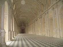 An ornate white hall with dozens of arches