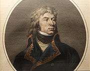 Color print of a long-haired man with a proud bearing. He wears a blue military coat trimmed with gold lace while there is a black kerchief at his throat.