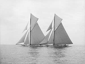 Black and white photograph of two racing yacht under full sail