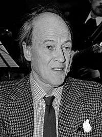 Head and shoulders photograph of Dahl, wearing jacket and tie; his hair is receding