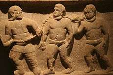 Relief wall sculpture of three slaves collared together