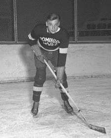 Conacher as a young man posting in full hockey uniform