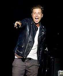 A shot of Ryan Tedder, looking to the left of a nearby camera.