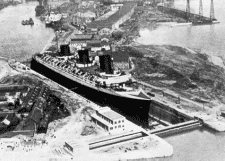 A large passenger liner dwarfs its surroundings