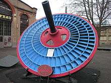 Blue disc-shaped turbine wheel with three blade rings.