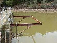 A photo showing a frame on Searsville Dam which at one time supported a diving platform