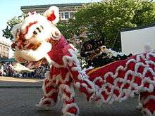 A lion dance, with bright red and white colours