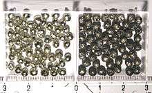 Many small, shiny, silver-coloured spheres on the left; many of the same sized spheres on the right are duller and darker than the ones of the left and have a subdued metallic shininess.