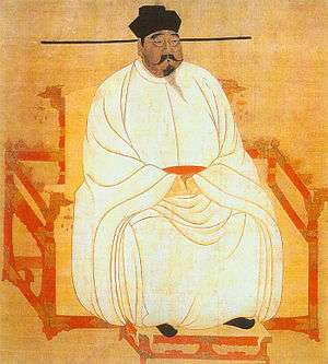 Painted image of a portly man sitting in a red throne-chair with dragon-head decorations, wearing white silk robes, black shoes, and a black hat, and sporting a black moustache and goatee.