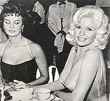 Sophia Loren and Jayne Mansfield, seated at a restaurant table
