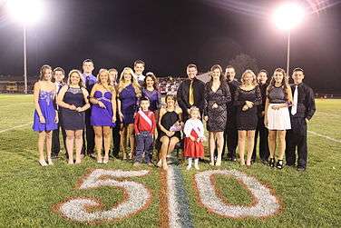 South Shelby's 2015 Homecoming Queen, Candidates and escorts take a pictures during halftime of the football game out on the 50 yard line.