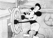 A cartoon mouse is operating a ship's steering wheel