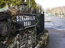 A 19th- or early 20th-century black tile street sign with the words "Stranmillis Road".