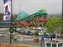 A view across Dreamworld and WhiteWater World's car park towards the Super Tubes Hydrocoaster and The Green Room