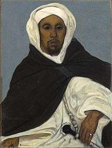 Thami El Glaoui in traditional tribal clothing with a dagger at his hip