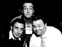 Peter Sellers, Spike Milligan and Harry Secombe pose around a BBC microphone