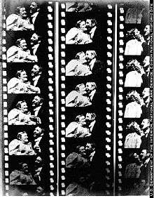 Three black-and-white film strips showing a woman and man facing each other and then eventually kissing. Each film strip has about five visible frames.