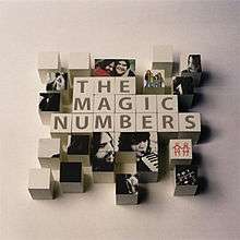 The phrase "The Magic Numbers" spelled out with children's toy blocks