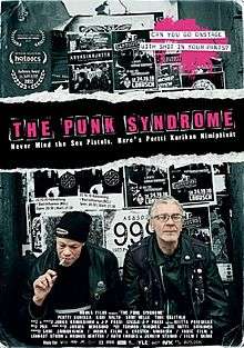 A poster featuring two members of the band sitting in front of black and white gig promotional posters.