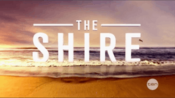 The Shire Text spread across a beach