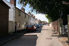 Sunny street with white clapperboard houses