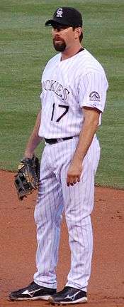 Todd Helton standing on the infield, looking left and wearing a baseball glove