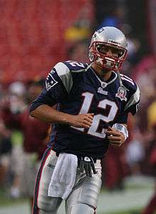 Tom Brady in football uniform, wearing uniform number 12