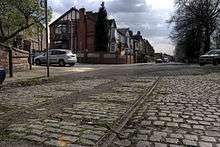 Tramlines running along a cobbled road in Broughton.