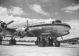 Four-engined civil airliner on airfield, bearing the legend "Trans Australia Airlines"