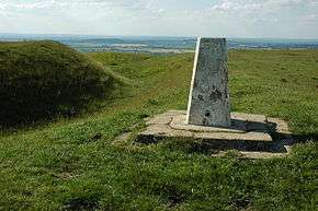 a concrete triangulation point and steepsided ramparts of close-cropped grass