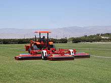 A typical roller mower operating on a sod grass farm.