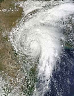A satellite image depicting a well-developed tropical cyclone moving across Mexico and Texas.